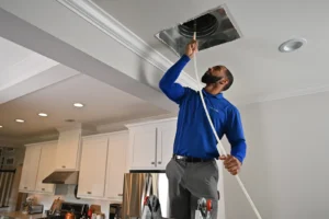 Technician performing HVAC maintenance – is duct cleaning a waste of money